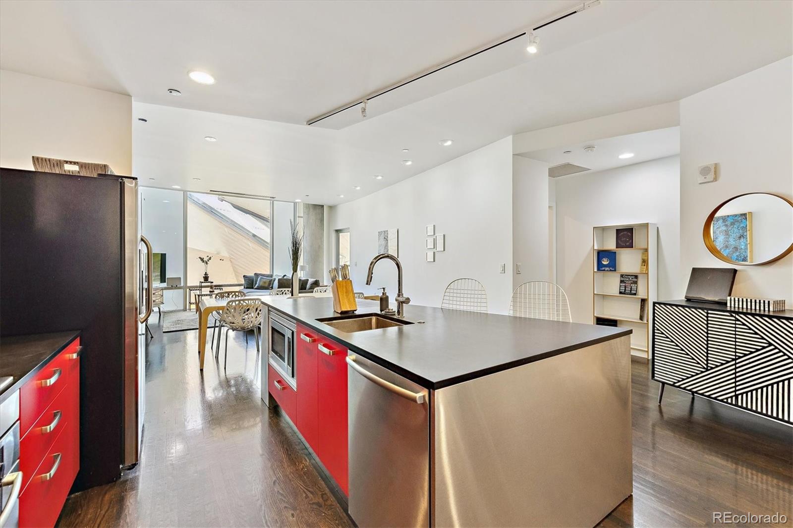 1200 Acoma Street, Unit 303 Denver, CO 80204 - Photo 11 of 48 a kitchen with stainless steel appliances granite countertop a refrigerator a sink a stove and a refrigerator