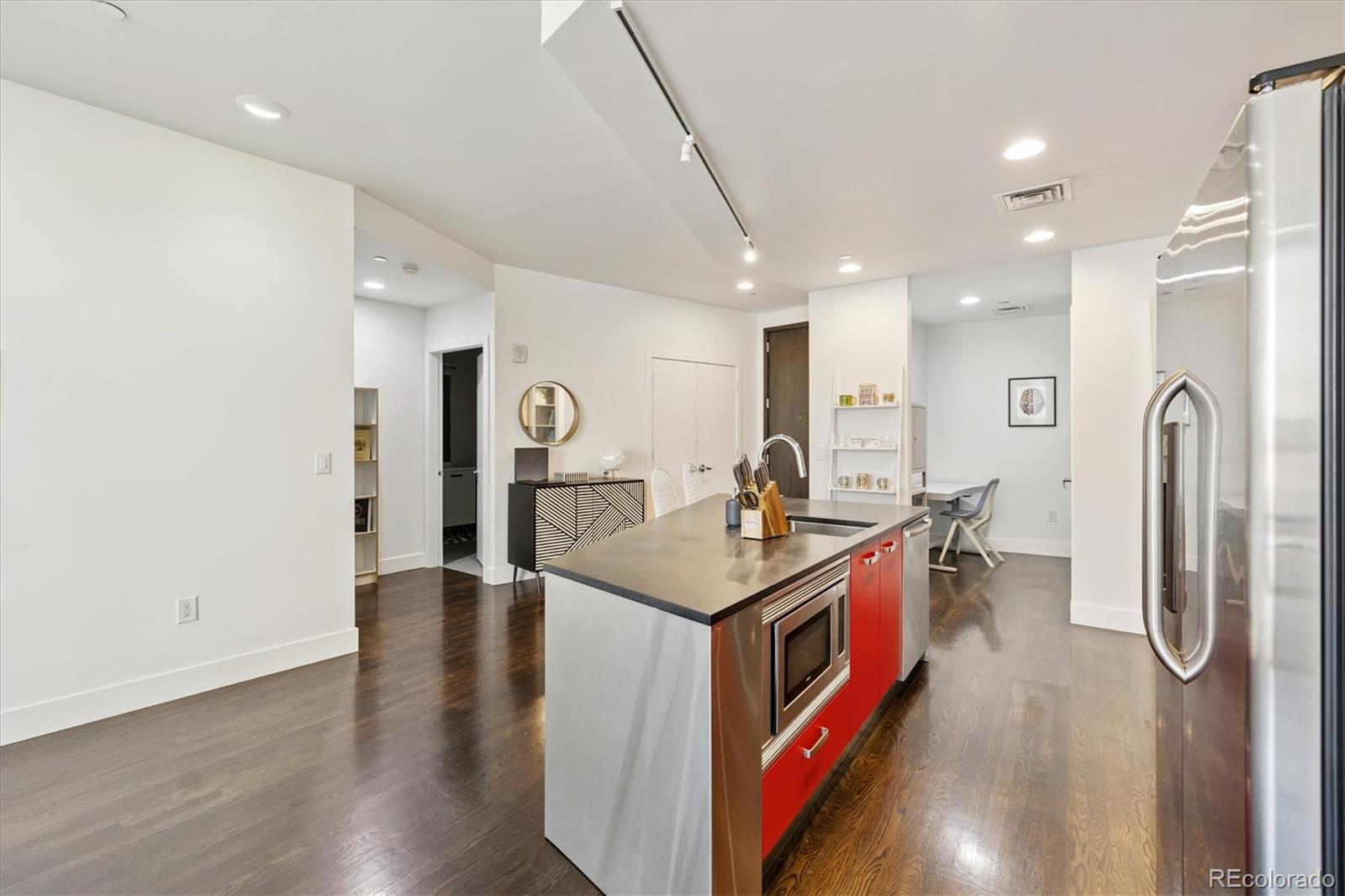 1200 Acoma Street, Unit 303 Denver, CO 80204 - Photo 12 of 48 a kitchen with stainless steel appliances granite countertop a sink and stove