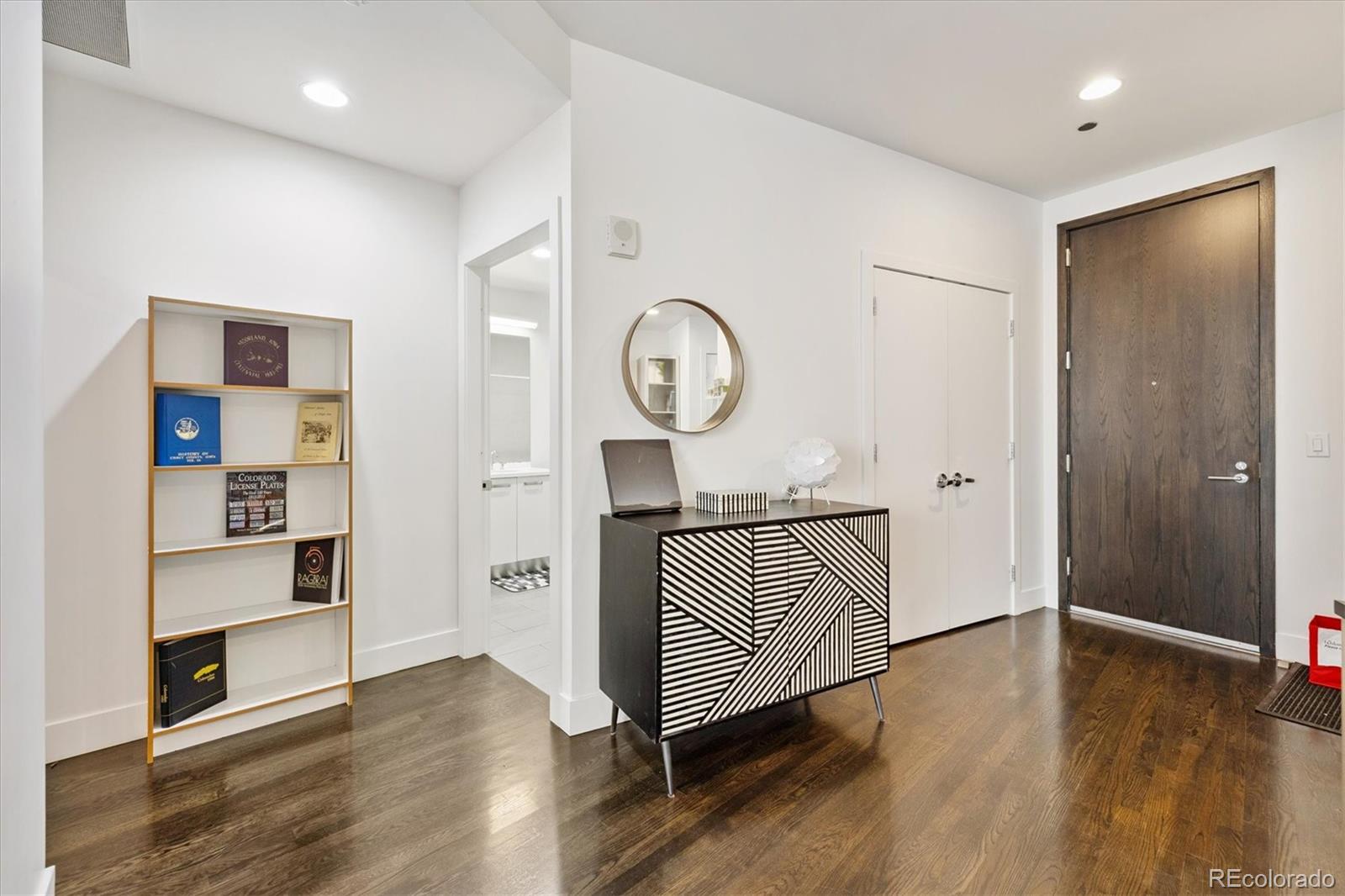 1200 Acoma Street, Unit 303 Denver, CO 80204 - Photo 13 of 48 a view of a hallway with wooden floor and cabinets