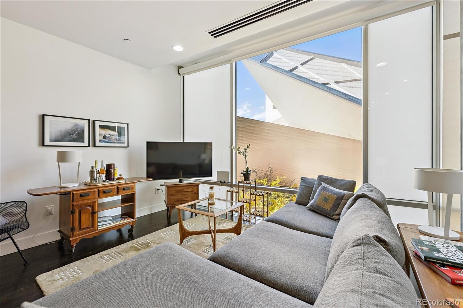 1200 Acoma Street, Unit 303 Denver, CO 80204 - Photo 15 of 48 a living room with furniture and a flat screen tv