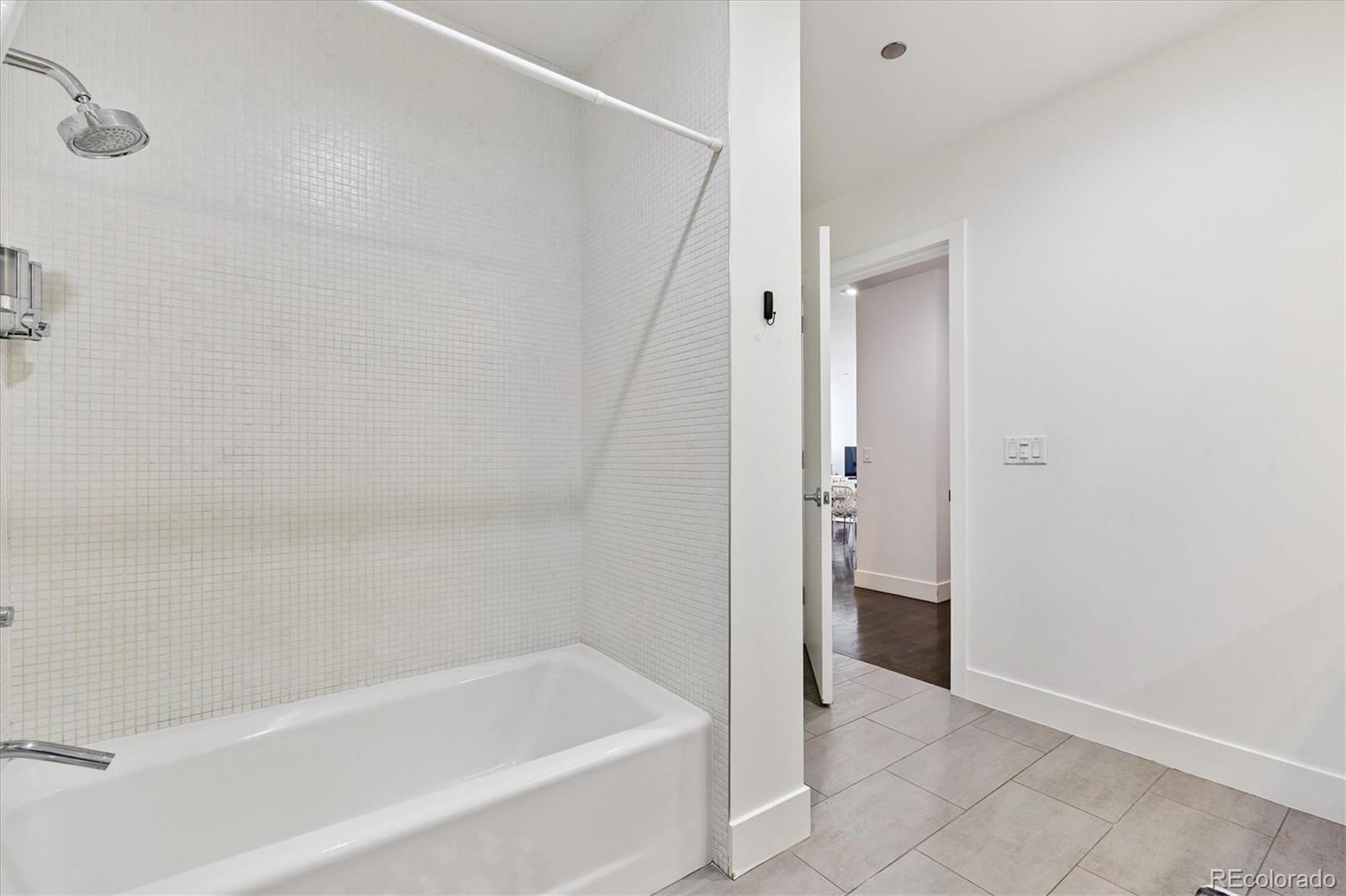 1200 Acoma Street, Unit 303 Denver, CO 80204 - Photo 21 of 48 a bathroom with a bathtub and shower