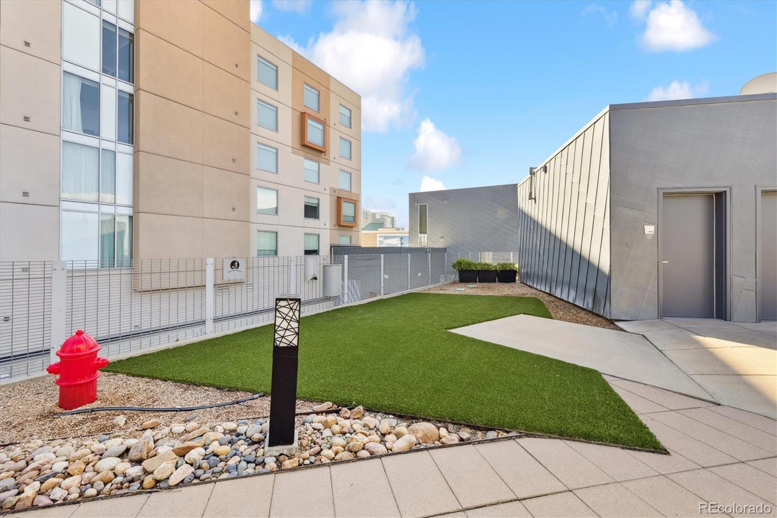 1200 Acoma Street, Unit 303 Denver, CO 80204 - Photo 30 of 48 a front view of a building with garden