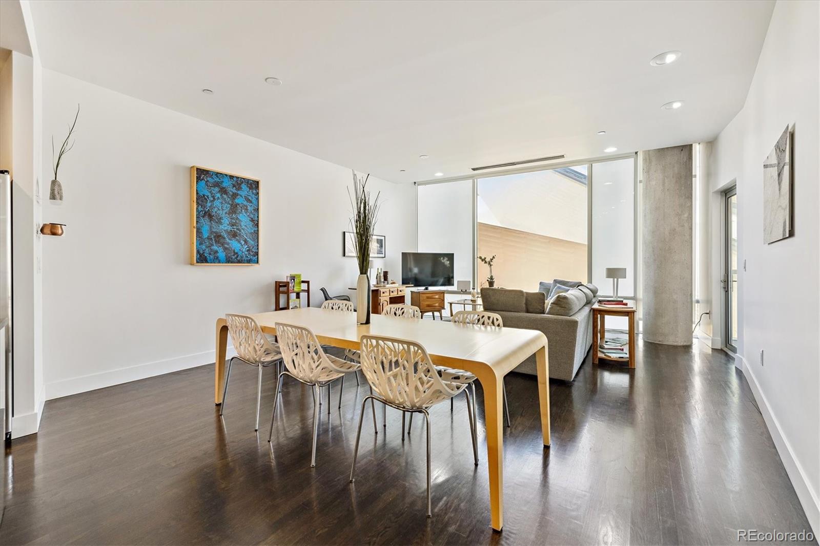 1200 Acoma Street, Unit 303 Denver, CO 80204 - Photo 3 of 48 a view of a dining room with furniture and wooden floor