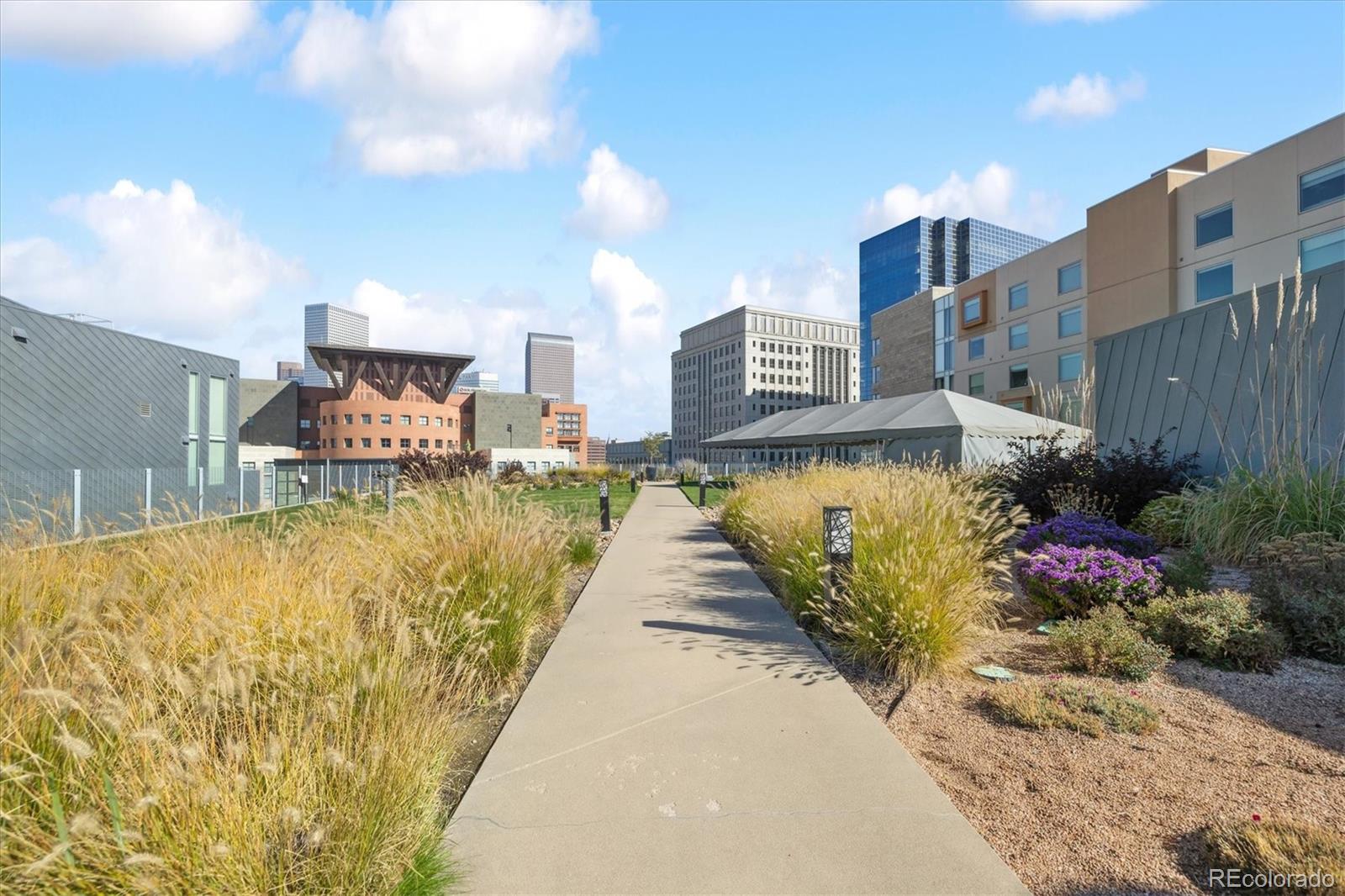1200 Acoma Street, Unit 303 Denver, CO 80204 - Photo 32 of 48 a view of a swimming pool with a lounge chair