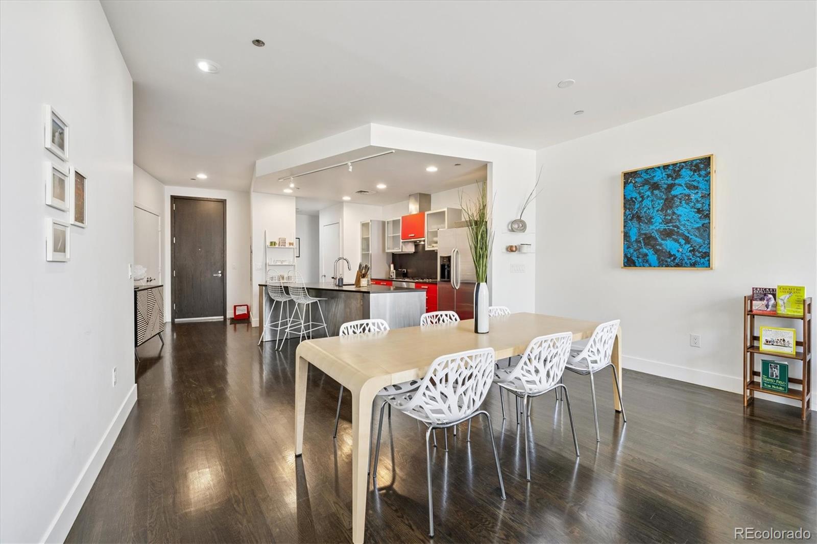 1200 Acoma Street, Unit 303 Denver, CO 80204 - Photo 4 of 48 a dining room with furniture and wooden floor
