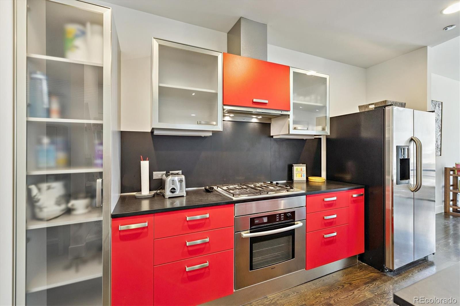 1200 Acoma Street, Unit 303 Denver, CO 80204 - Photo 10 of 48 a kitchen with stainless steel appliances granite countertop a refrigerator and a stove