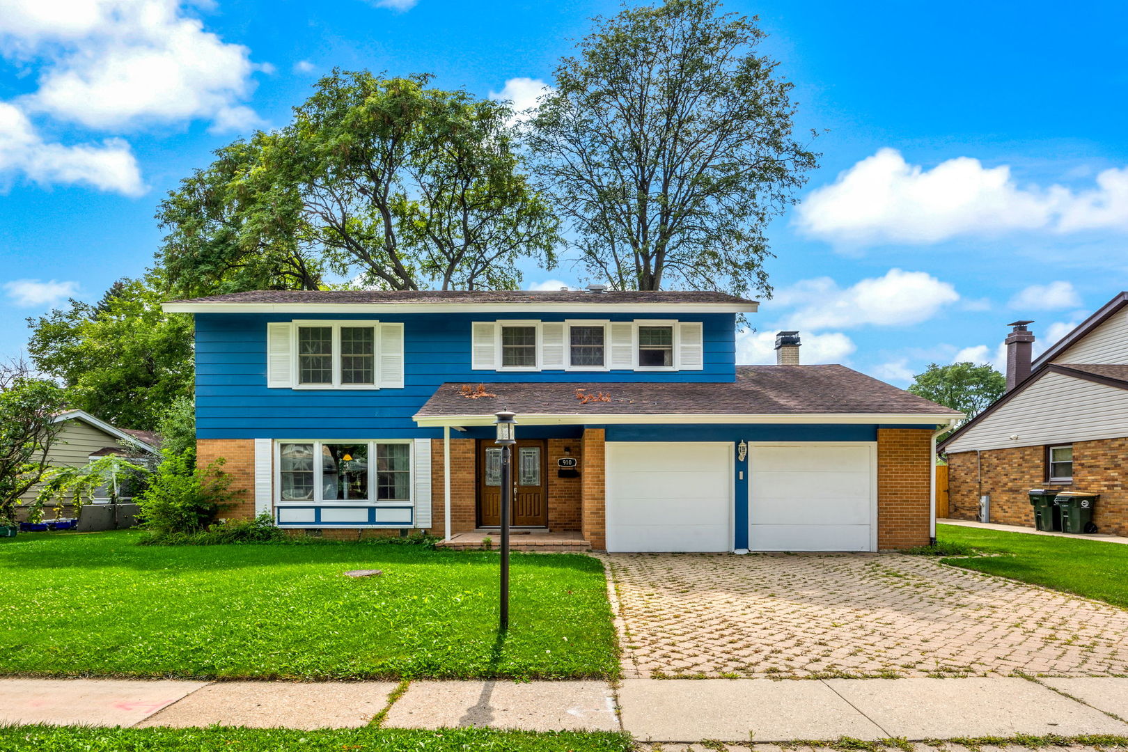 a front view of a house with a garden