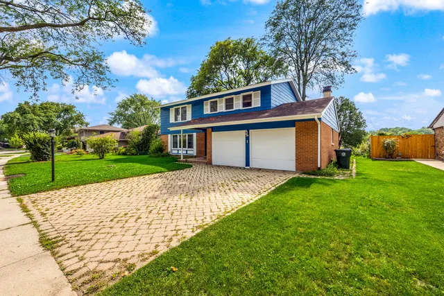 a view of house with backyard