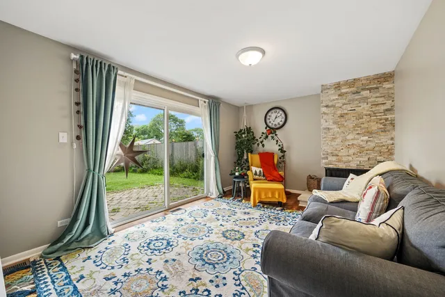 a living room with furniture and a floor to ceiling window