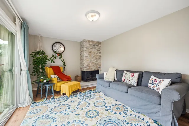 a living room with furniture a rug and a large window