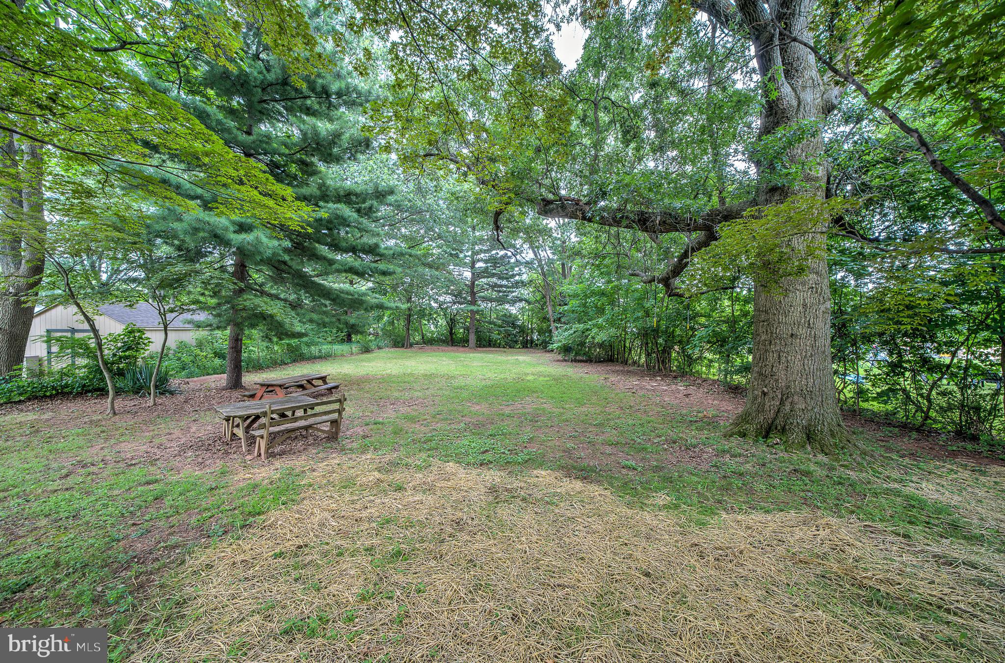 2031 Oak Road Hatfield, PA 19440 - Photo 45 of 59 a view of a backyard with a bench and trees