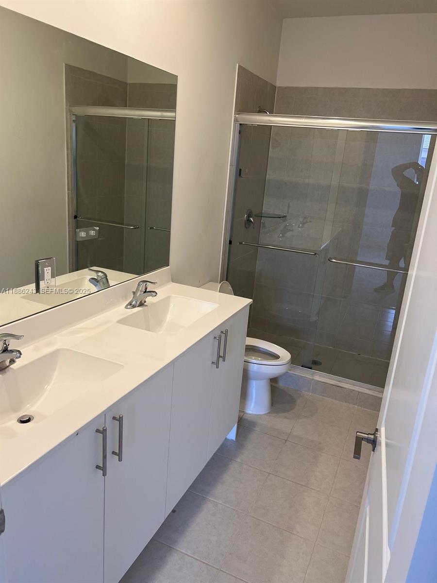 26413 Southwest 149th Avenue, Unit 26413 Homestead, FL 33032 - Photo 15 of 29 a bathroom with a sink toilet and shower