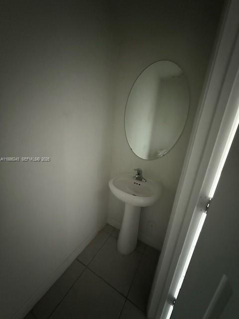 26413 Southwest 149th Avenue, Unit 26413 Homestead, FL 33032 - Photo 17 of 29 a bathroom with a sink toilet and mirror