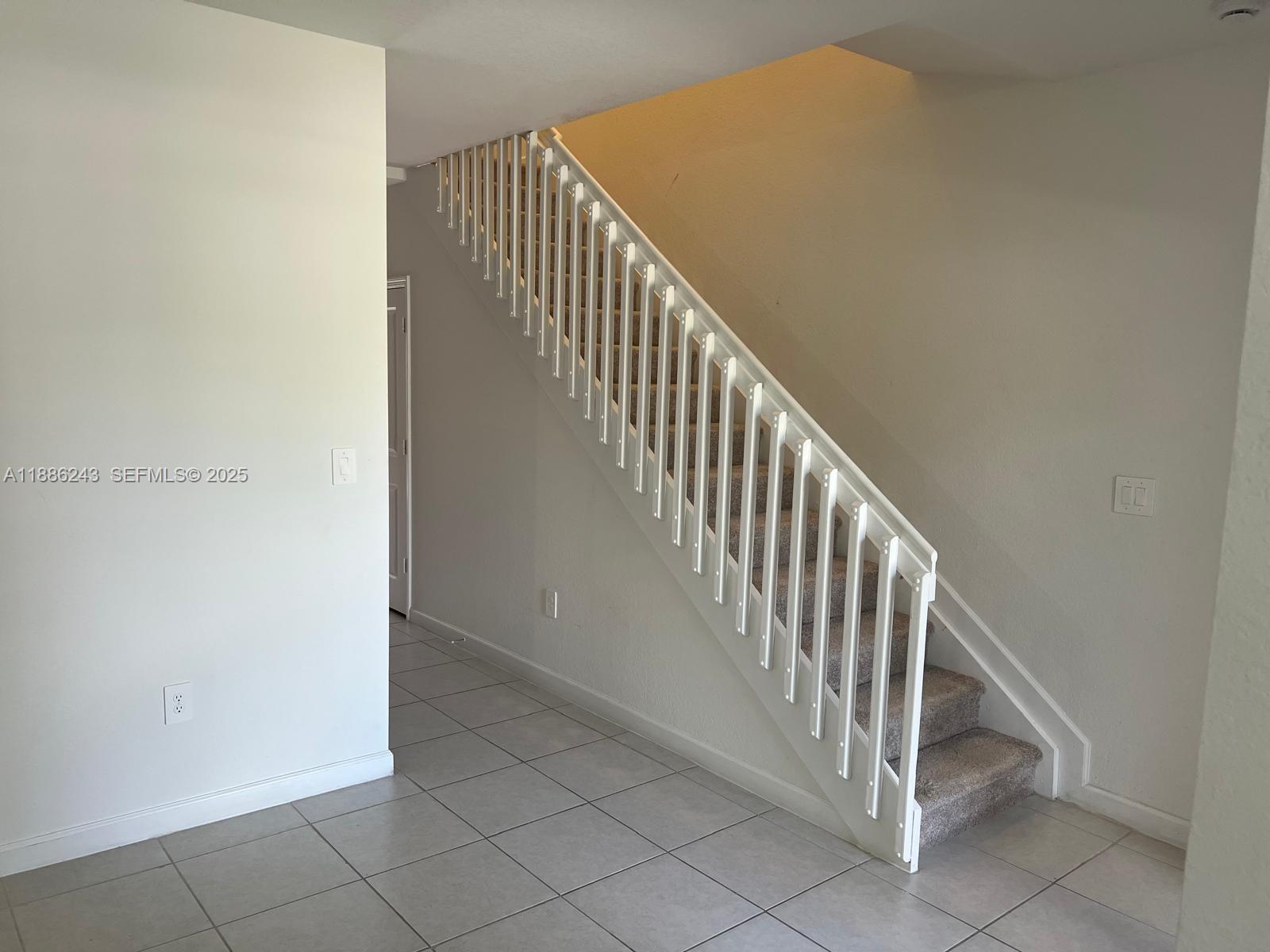 26413 Southwest 149th Avenue, Unit 26413 Homestead, FL 33032 - Photo 6 of 29 a view of a hallway with staircase