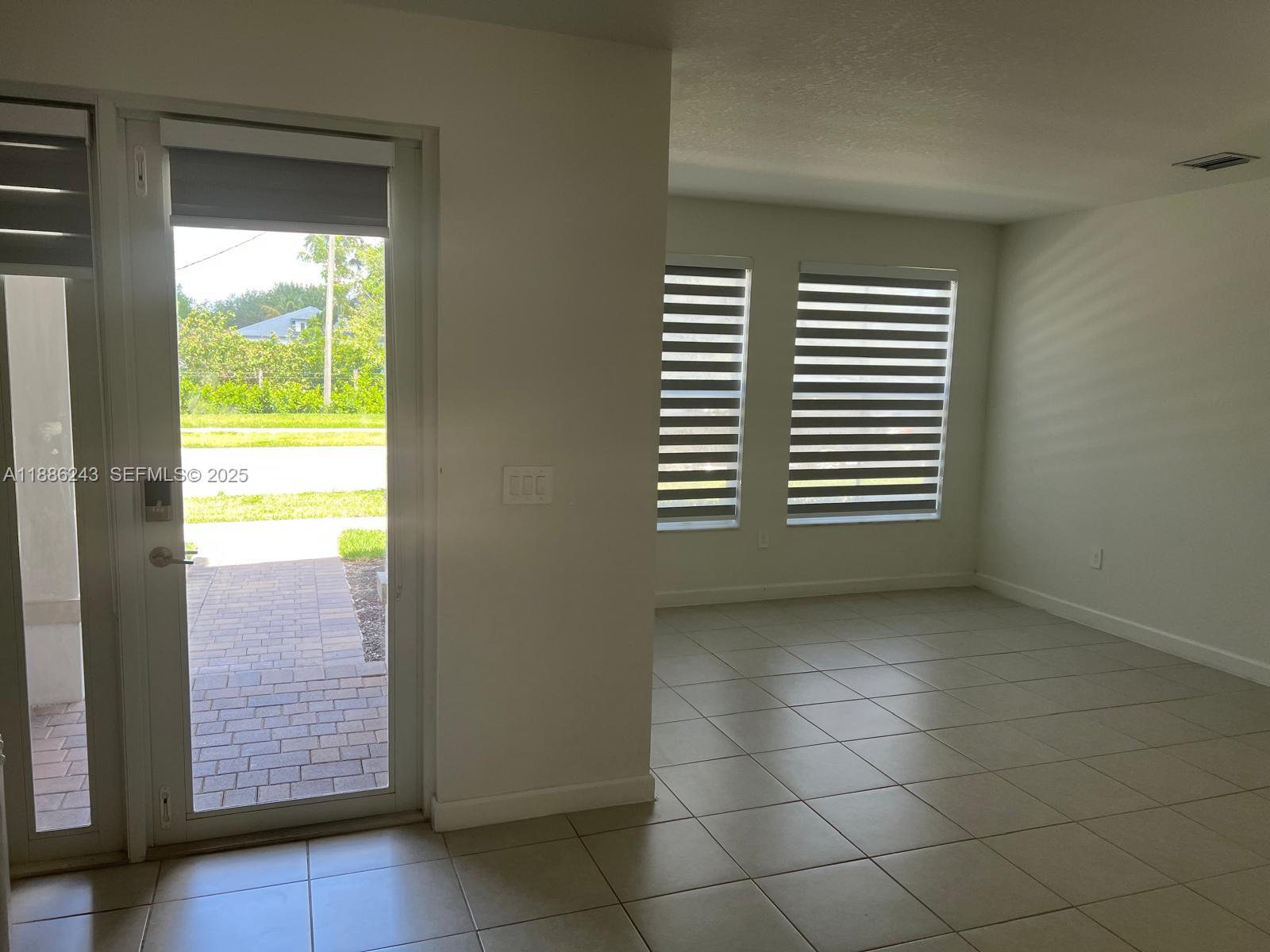 26413 Southwest 149th Avenue, Unit 26413 Homestead, FL 33032 - Photo 7 of 29 a view of empty room and window