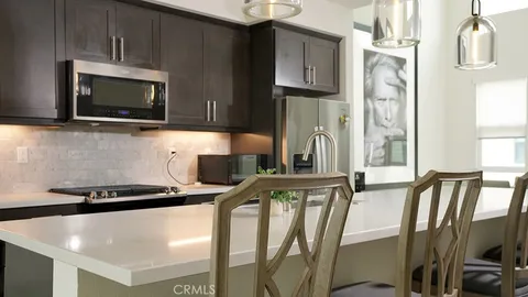 a kitchen with kitchen island a cabinets counter space and stainless steel appliances