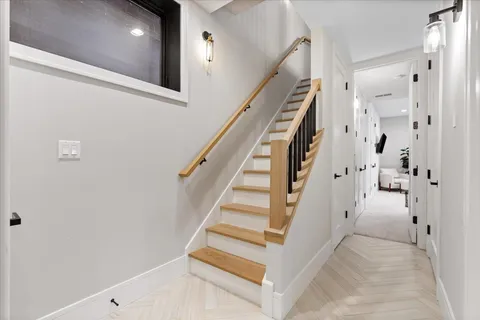 a spacious bedroom with a bed and glass door