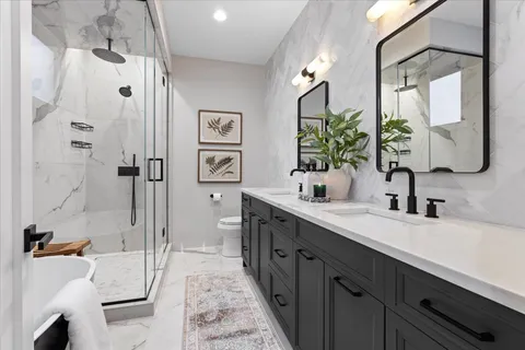 a bathroom with a sink toilet and shower