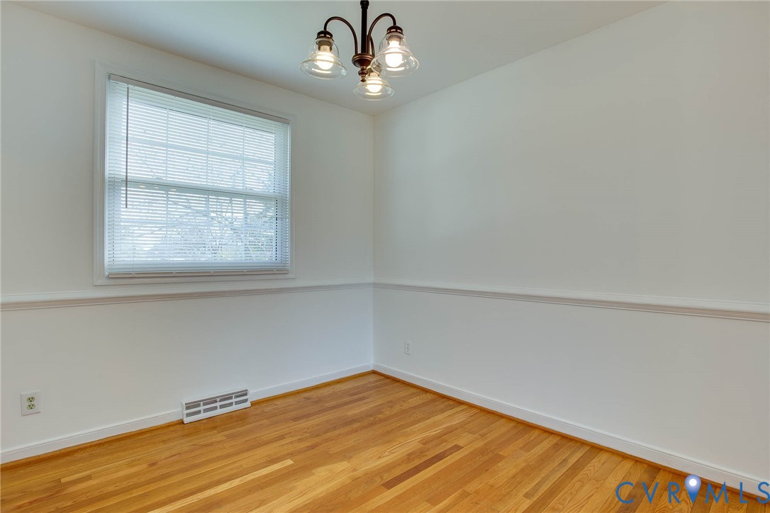 3909 Longleaf Drive Henrico, VA 23294 - Photo 15 of 39 Spare room featuring a chandelier and wood finishe