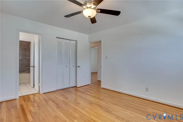 a view of empty room with ceiling fan