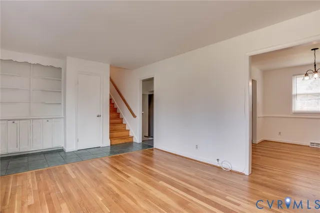 a view of a room with wooden floor and staircase