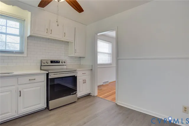 a kitchen with granite countertop white cabinets and white appliances