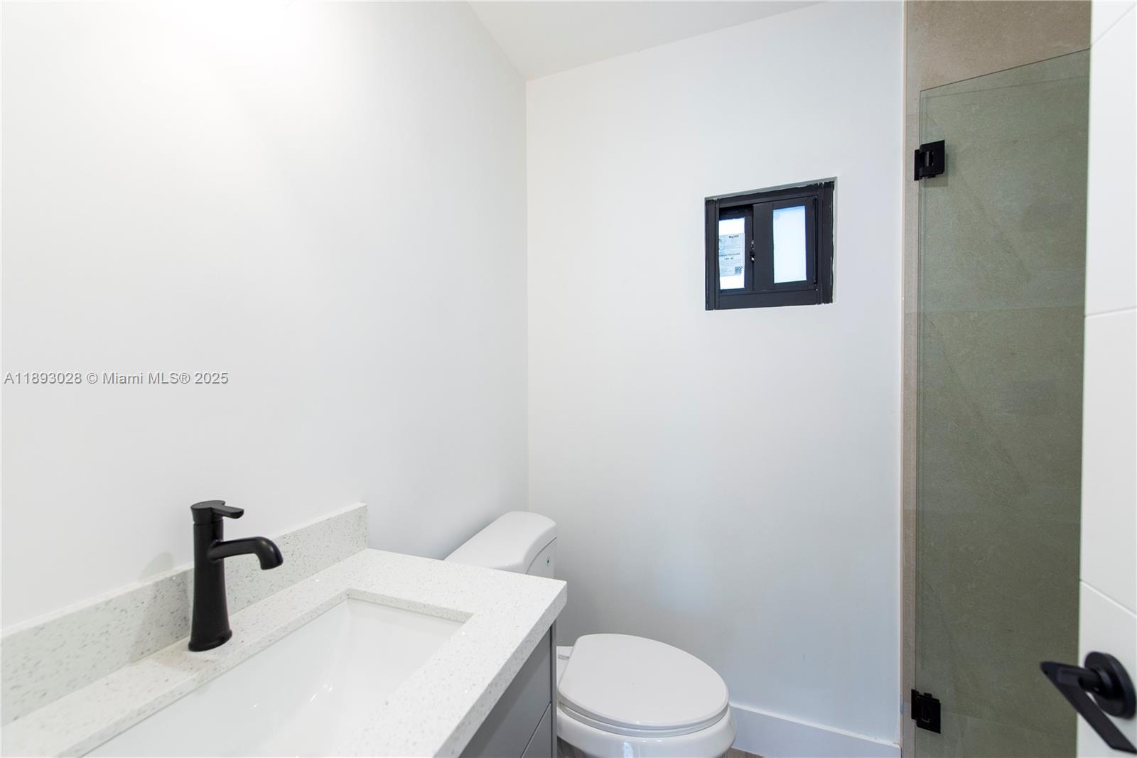 764 Northwest 36th Avenue, Unit 1 Miami, FL 33125 - Photo 14 of 17 a white toilet sitting next to a sink