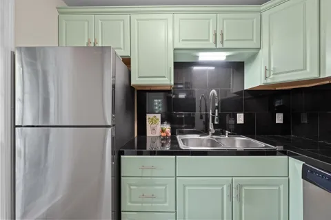 a kitchen with a refrigerator and cabinets