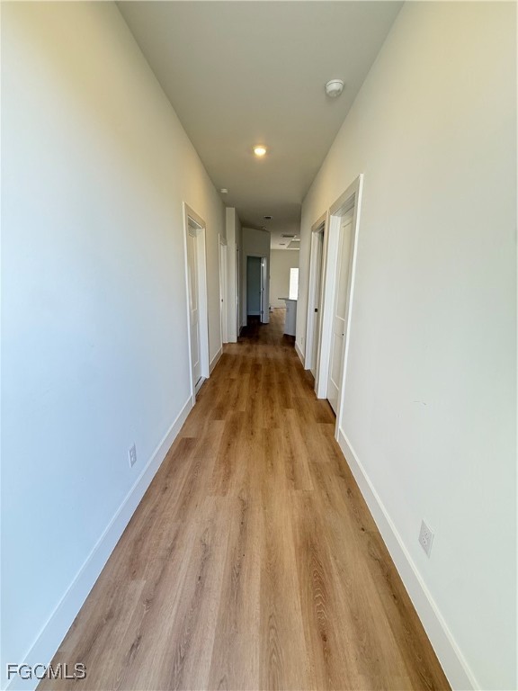 4719 28th Street Southwest Lehigh Acres, FL 33973 - Photo 2 of 13 a view of a hallway with wooden floor