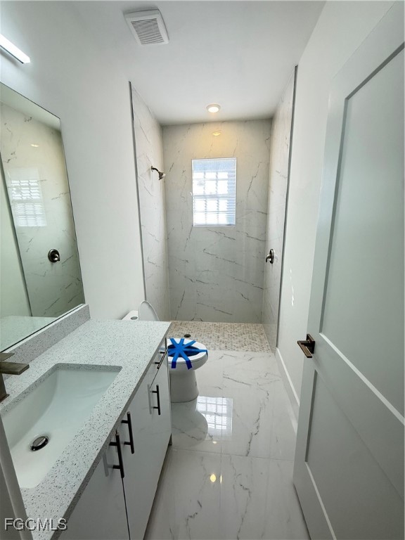 4719 28th Street Southwest Lehigh Acres, FL 33973 - Photo 7 of 13 a bathroom with a sink a toilet and shower