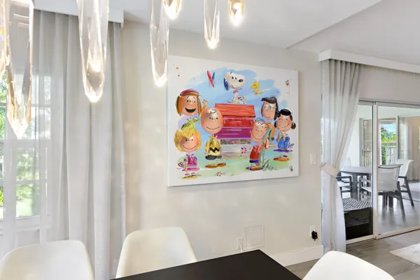 a white couch sitting next to a white curtain