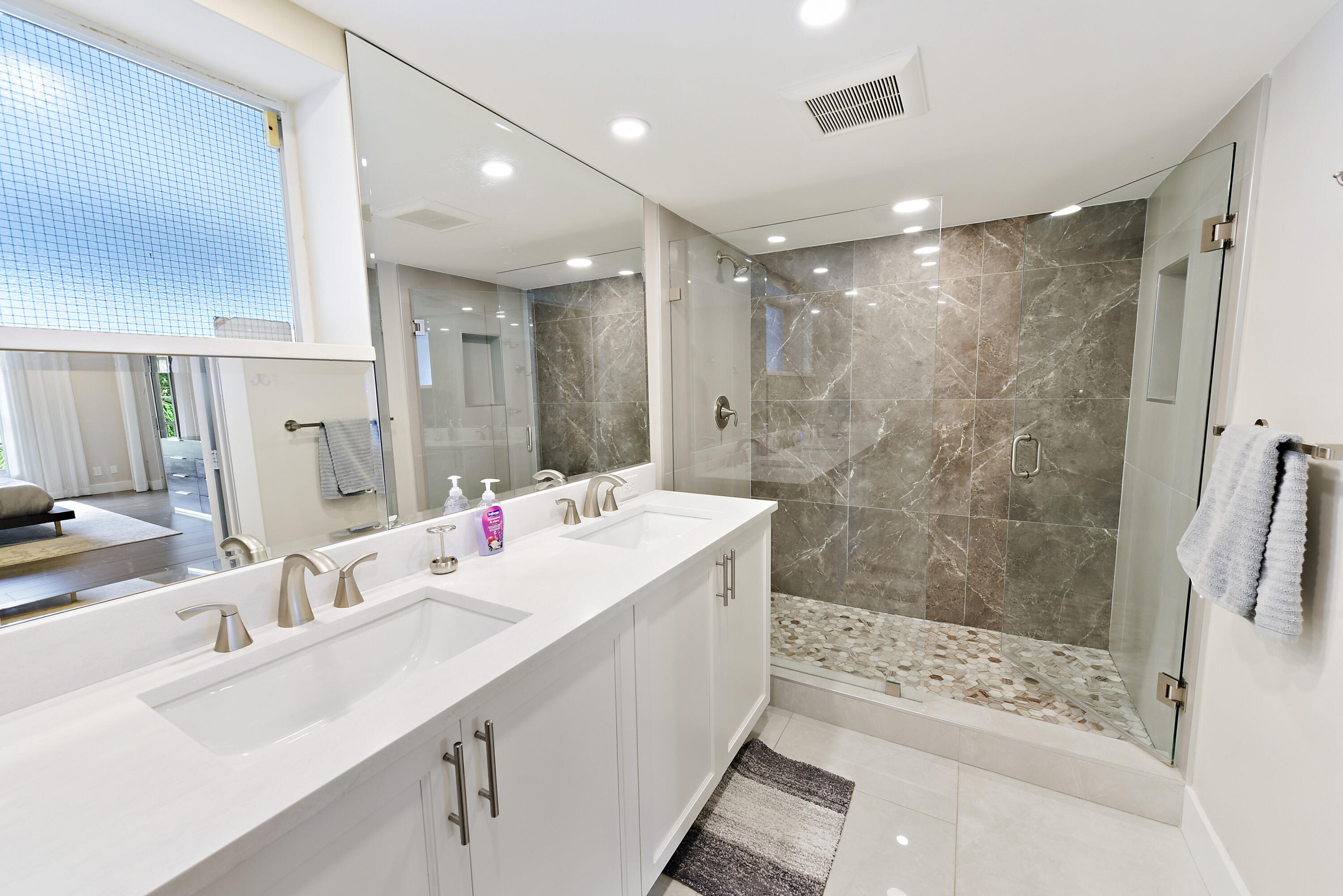 7369 Orangewood Lane, Unit 301 Boca Raton, FL 33433 - Photo 24 of 53 a bathroom with a sink double vanity and shower