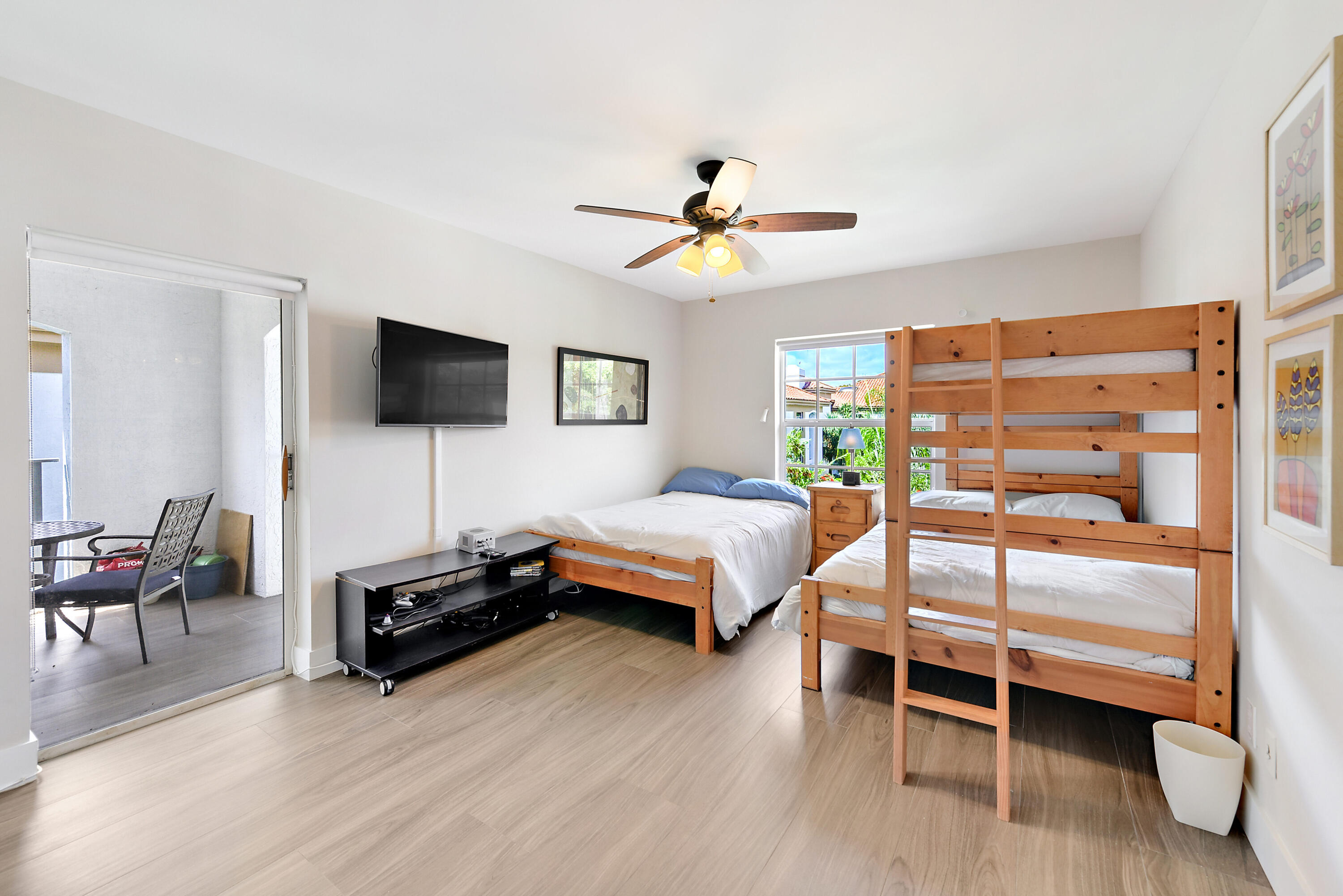 7369 Orangewood Lane, Unit 301 Boca Raton, FL 33433 - Photo 25 of 53 a bedroom with furniture and a flat screen tv