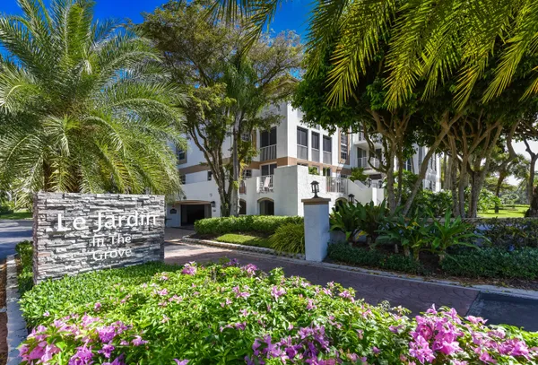 a view of a garden with flowers and trees