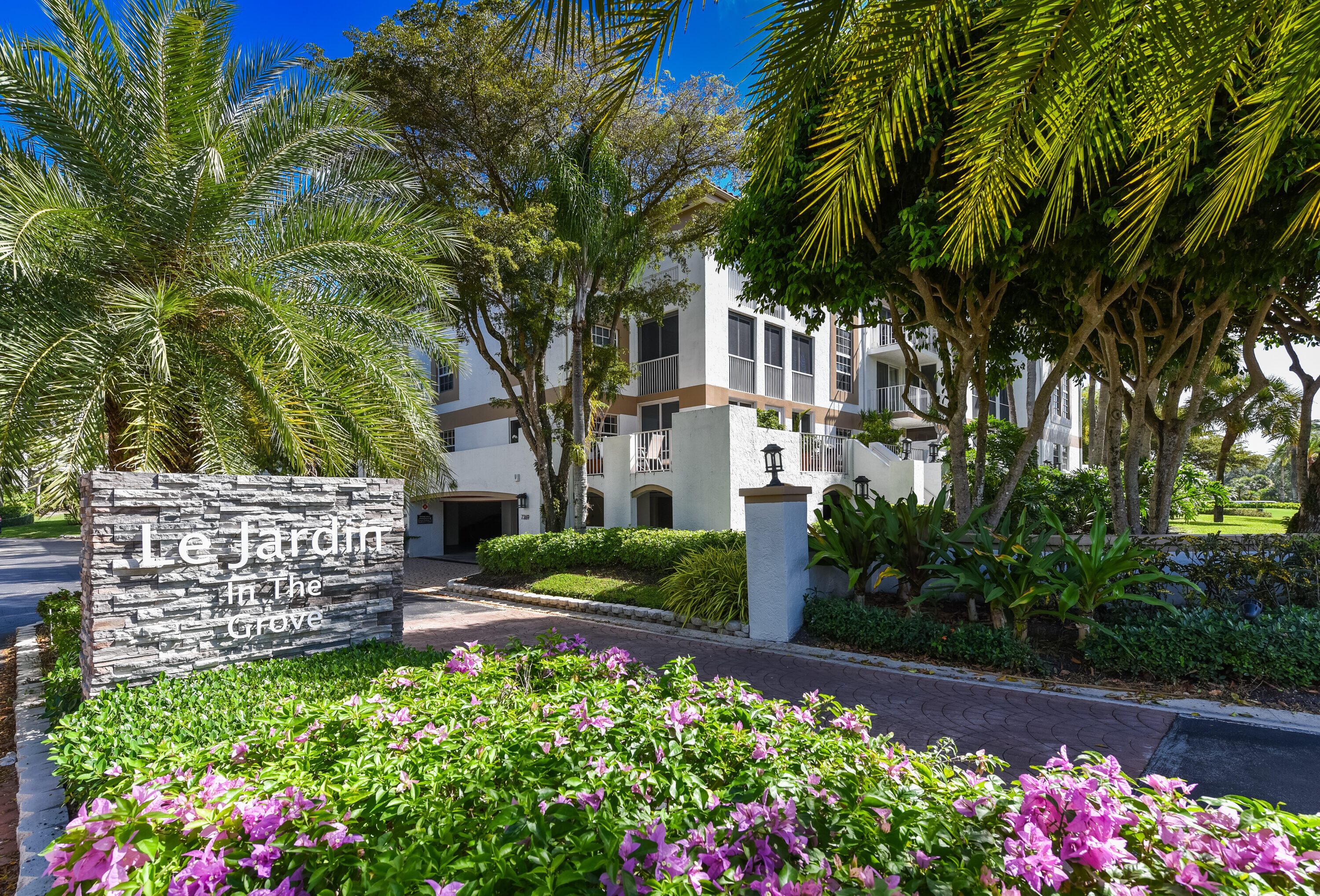 7369 Orangewood Lane, Unit 301 Boca Raton, FL 33433 - Photo 30 of 53 a view of a garden with flowers and trees