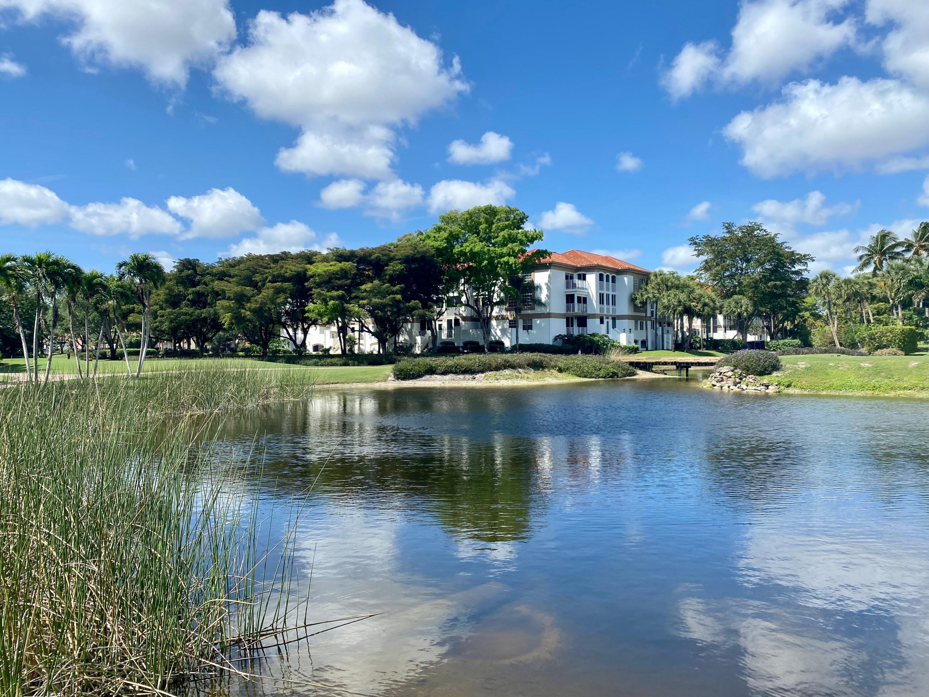 7369 Orangewood Lane, Unit 301 Boca Raton, FL 33433 - Photo 3 of 53 a view of a lake with houses in the background