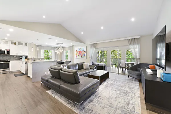 a living room with fireplace furniture and a large window