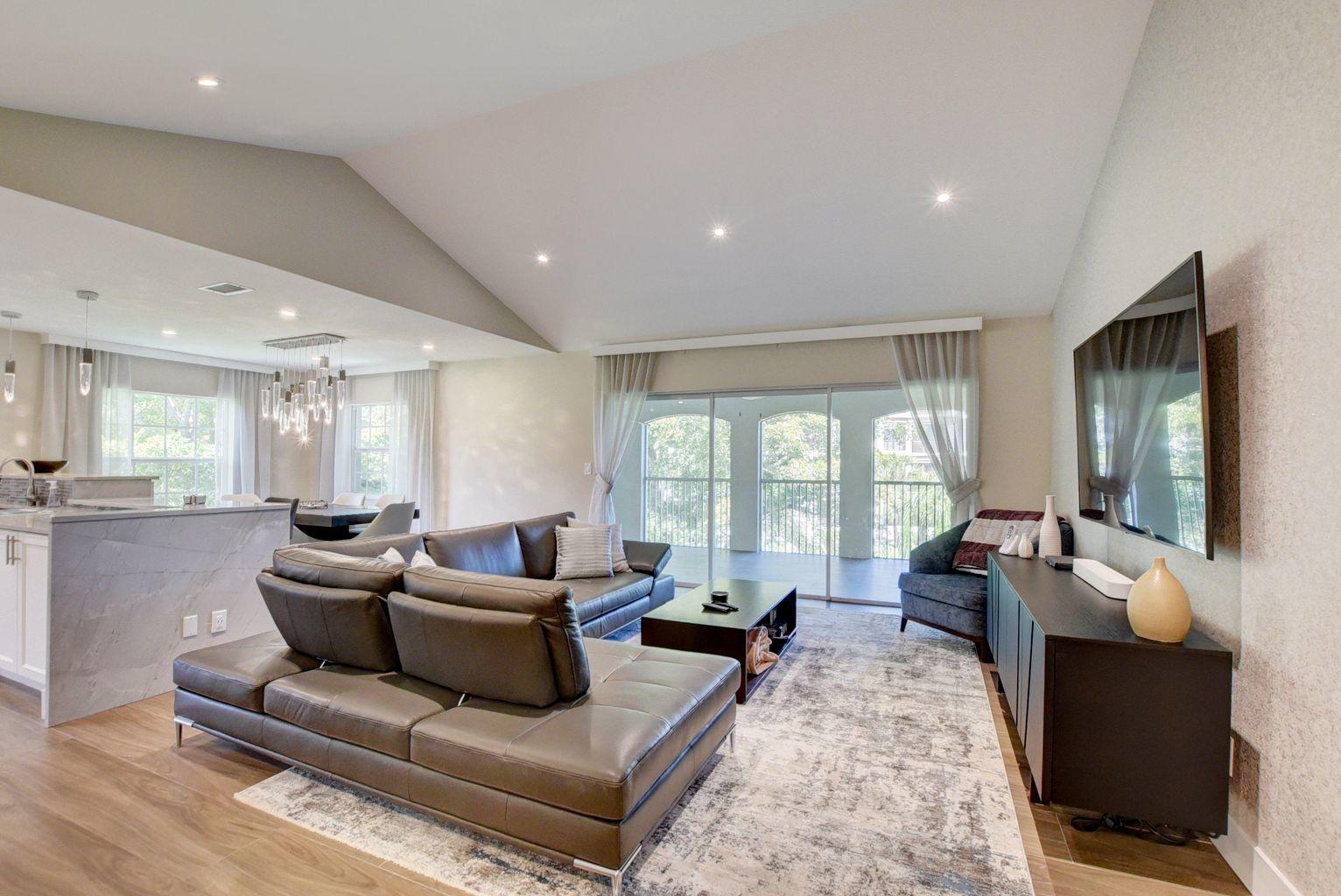 7369 Orangewood Lane, Unit 301 Boca Raton, FL 33433 - Photo 8 of 53 a living room with furniture and a large window