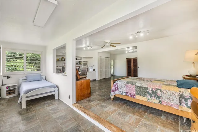 a bedroom with a bed and large window