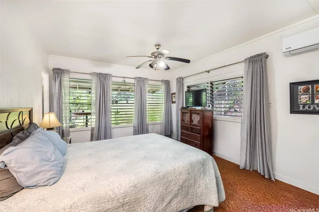 a bedroom with a large bed and a chandelier