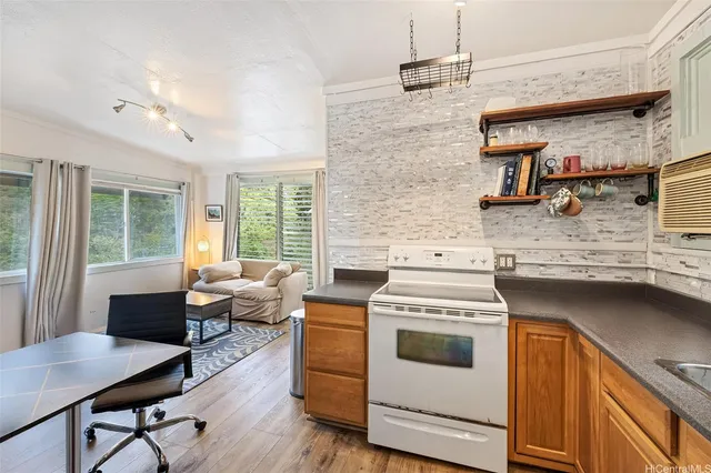 a kitchen with a stove and a wooden floor