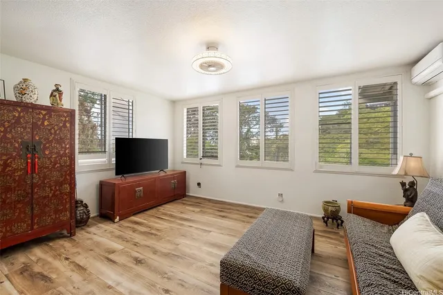 a bedroom with a bed and a television