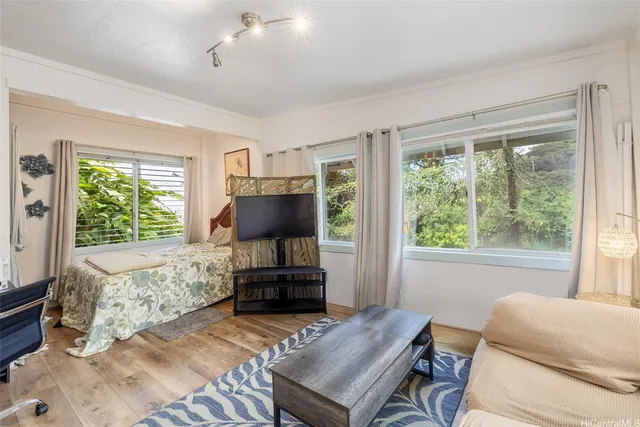 a living room with furniture a window and a flat screen tv