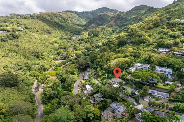 a view of a houses with a lush green hillside