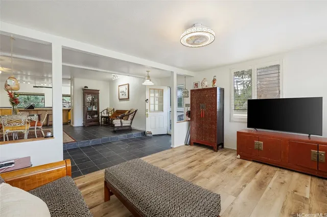 a bedroom with furniture and a flat screen tv