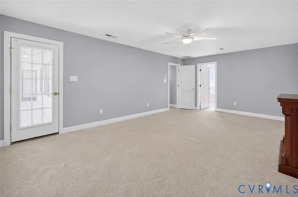 an empty room with windows and closet