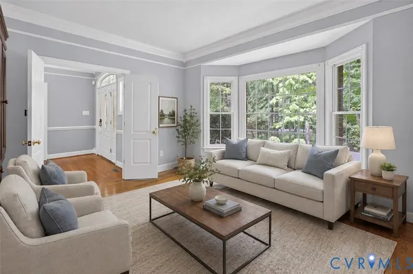 an empty room with wooden floor fireplace and windows