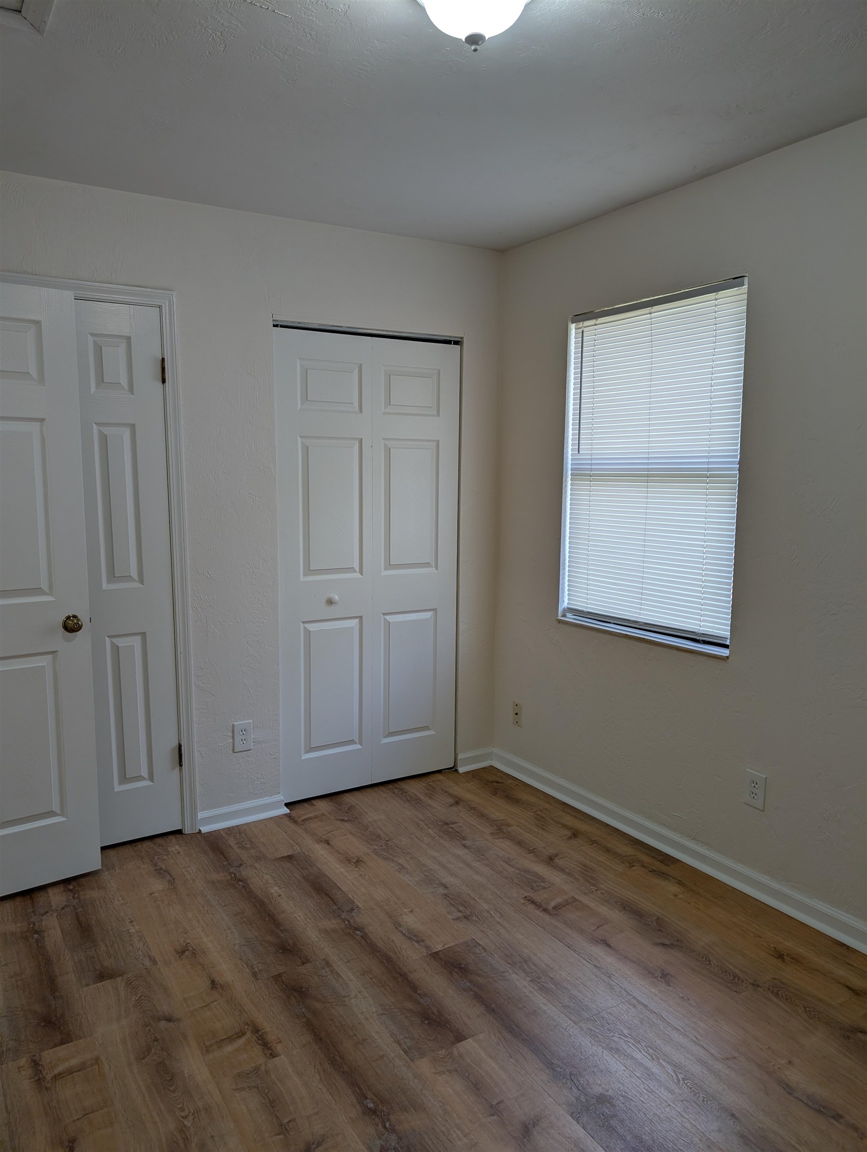 3891 Osprey Circle, Unit B St. Augustine, FL 32086 - Photo 11 of 18 a view of an empty room with wooden floor and closet