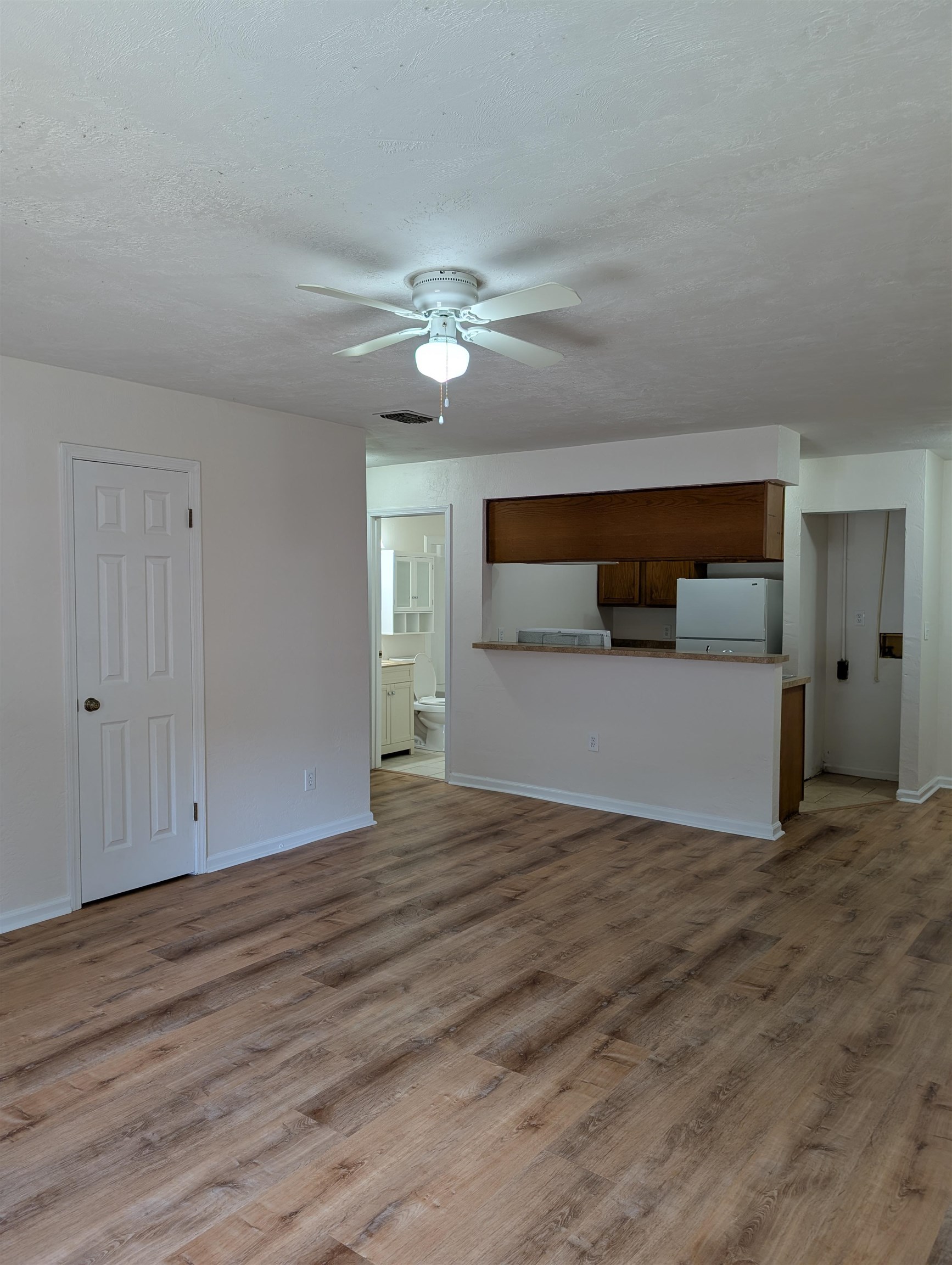 3891 Osprey Circle, Unit B St. Augustine, FL 32086 - Photo 12 of 18 a view of empty room with wooden floor and fan