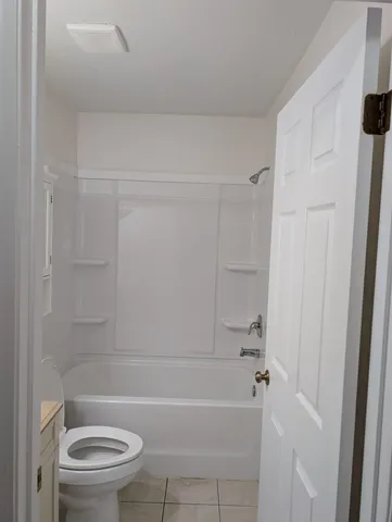 a bathroom with a bathtub and a toilet